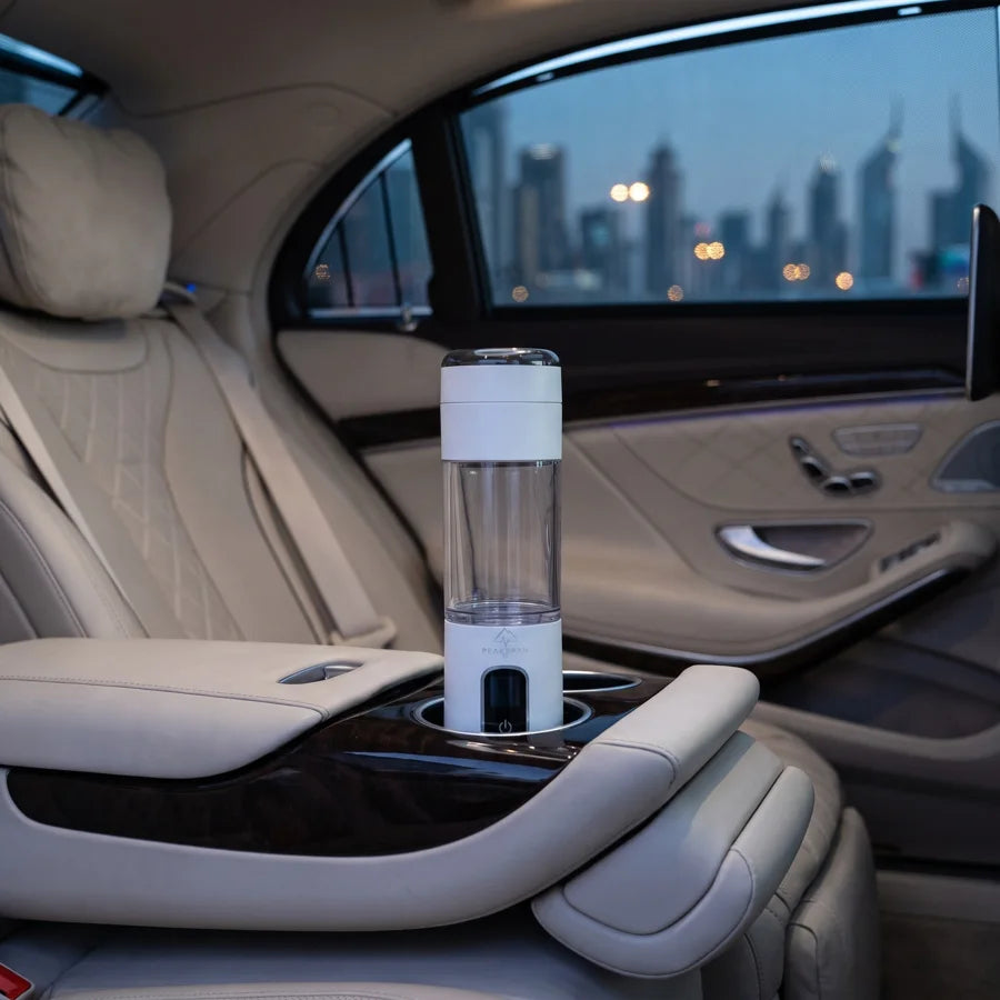 H2 Quantum Flask in the cup holder of a chauffeured car, Dubai at dusk